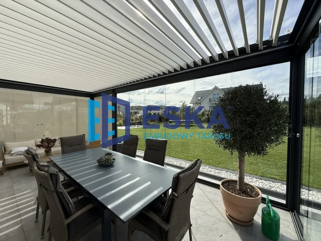 Nowoczesna zabudowa tarasu ESKA z lamelowym dachem i szklanymi ścianami, jadalnia z widokiem na ogród